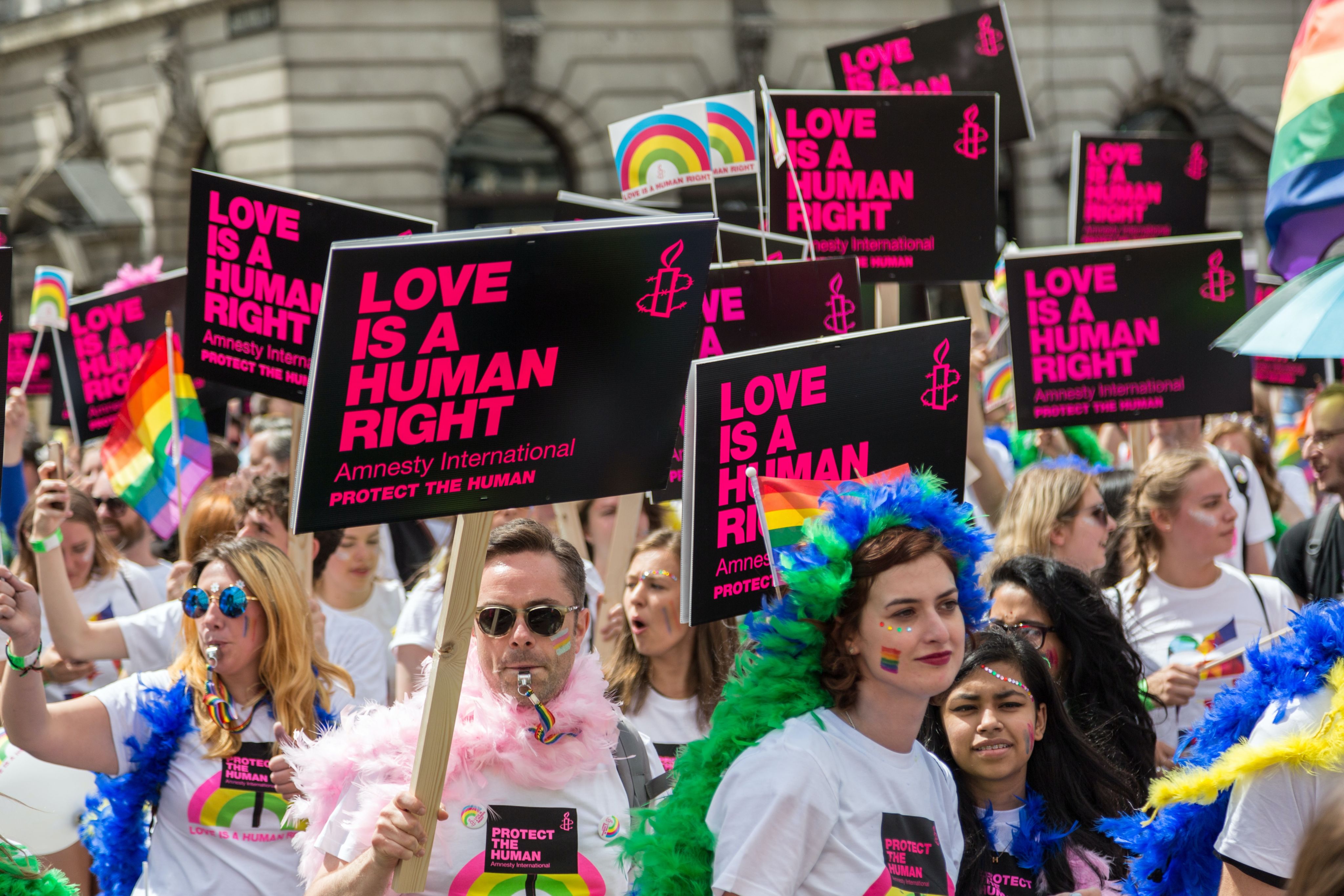 people holding love is a human right placard